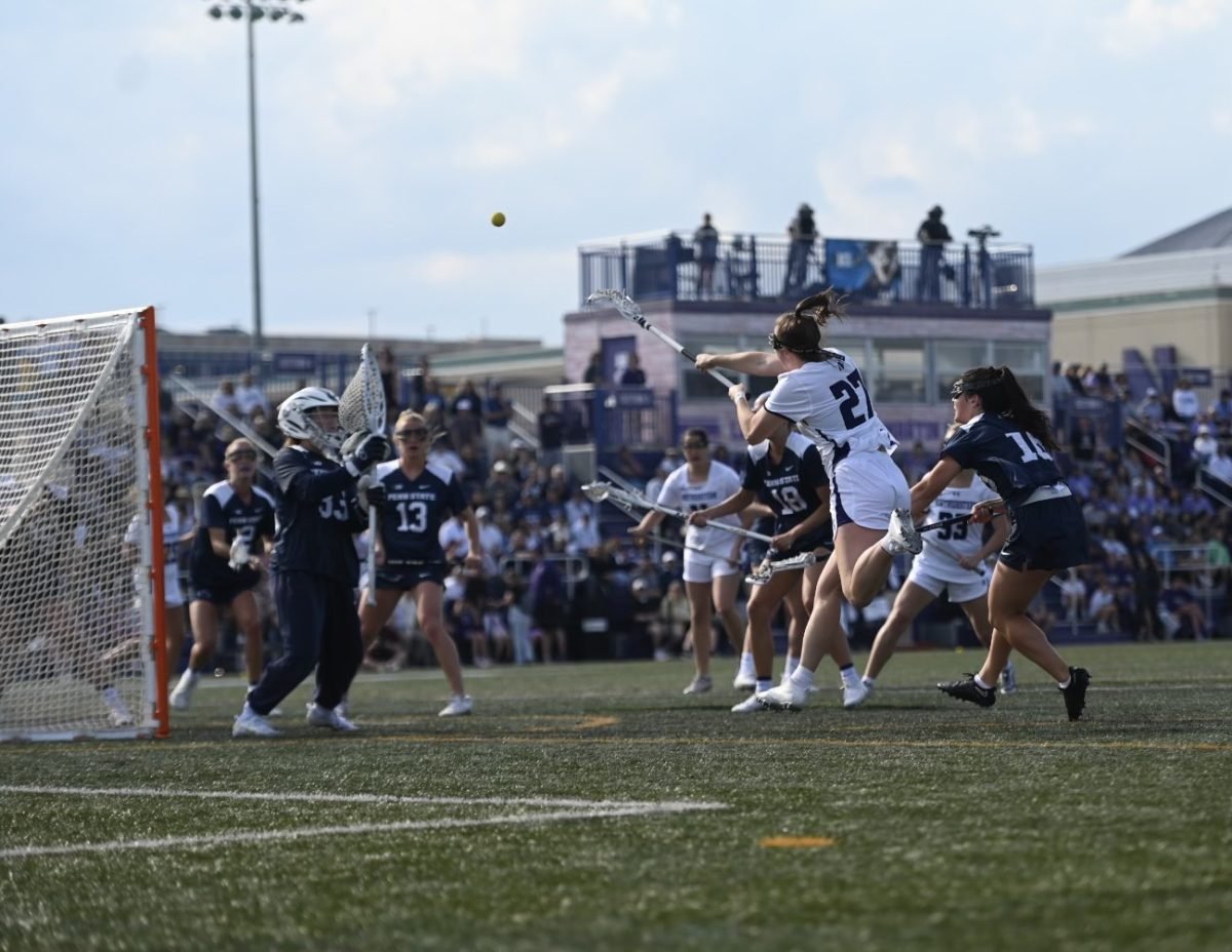Graduate student attacker Izzy Scane attempts a flying effort toward cage against Penn State Saturday. Scane scored five goals to help Northwestern win its second consecutive Big Ten Tournament championship.